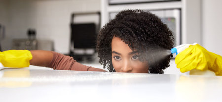 Cleaning, spray and table with woman in kitchen for hygiene, disinfectant or sanitary. Safety, germ...