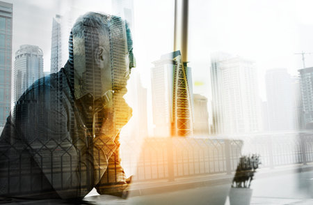 Conceptualizing his success. a businessman using a laptop in his office superimposed over a...