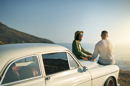 Beautiful views make for beautiful conversations. a young couple making a stop at the beach while...