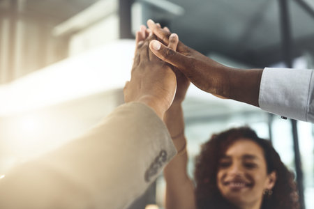 Were making our way towards our goals. Closeup shot of a group of businesspeople giving each other a...