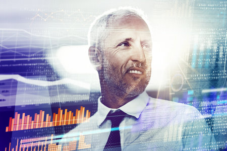 The digital world is his domain. a mature businessman working on programming code.の写真素材