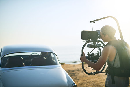 Capturing the best moments. a focused young man shooting a scene with a state of the art video...