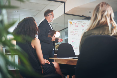 Where ideas flow, business grows. a mature businessman delivering a presentation in the boardroom of...