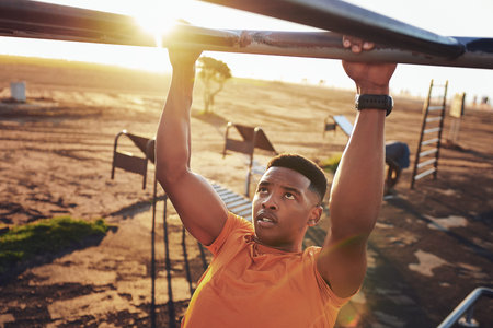 Stay dedicated to the things that make you better. a young man working out at the outdoor gym at the...