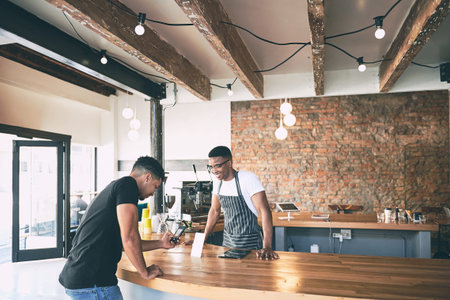 Get good coffee in a snap. a man using a smartphone to make a contactless payment in a cafe.