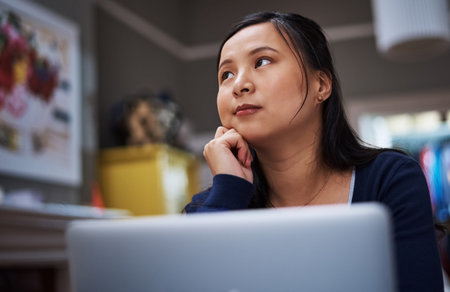 Think first, act second. an attractive young female entrepreneur looking thoughtful while working...