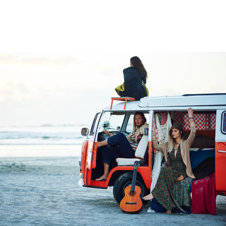 Go where the journey takes you. a group of young friends stopping at the beach during a roadtrip.の写真素材