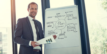 Hes got some interesting insights to share. a businessman giving a presentation in the boardroom.
