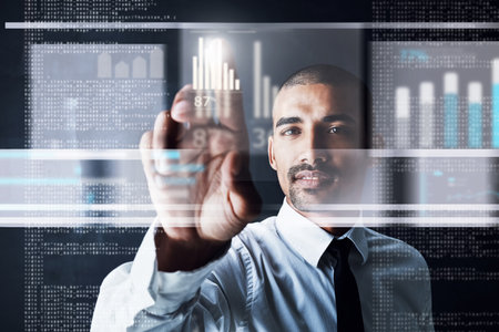 Touching the future. a handsome young businessman using a digital interface.の写真素材