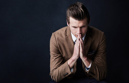 Not every move is a good move. Studio shot of a businessman looking worried against a dark background.の写真素材