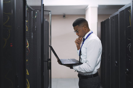 Fixing this will be no problem. a young male technician working in a server room.