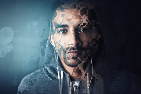 His concentration wont be broken. Studio portrait of a sporty young man standing against a dark background.の写真素材