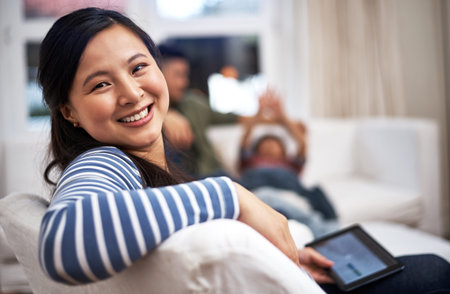 Browsing the weekend away. a person using a digital tablet at home.