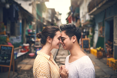 I love my life knowing youre in it. a young couple sharing a romantic moment in the city of Vietnam.の写真素材