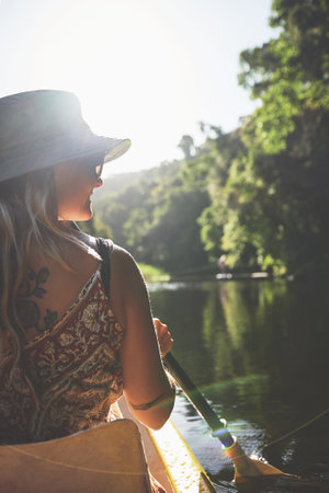 Life teaches you to just go with the flow. a young woman out kayaking on a lake.の写真素材