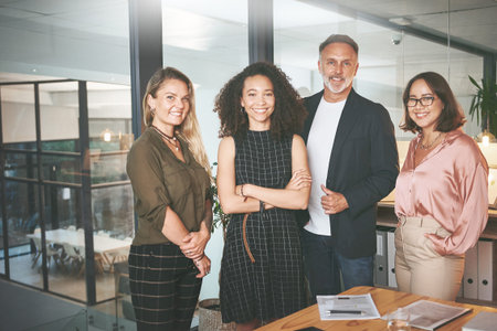 Were on our way to great success. a diverse group of businesspeople standing together in the office...