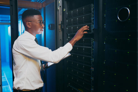 Youre going to need to be replaced. a young IT specialist standing alone in the server room and...