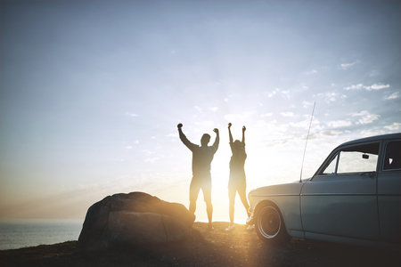 Think of life as an adventure. a young couple making a stop at the beach while out on a road trip.の写真素材