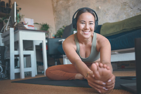 Got to prepare my body well. Portrait of a young woman stretching her legs while exercising at home.