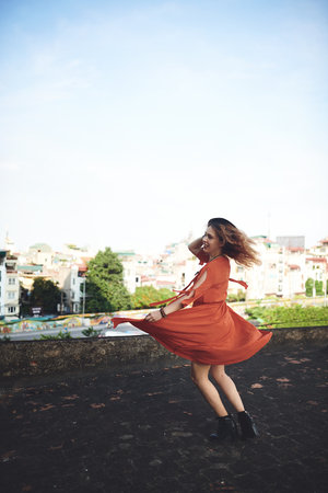 I hope you find what sets your soul on fire. a beautiful young woman posing on the rooftop of a building.の写真素材
