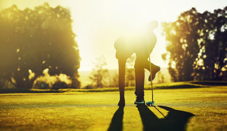 The more you practice the more you make it. a young man playing golf.の写真素材