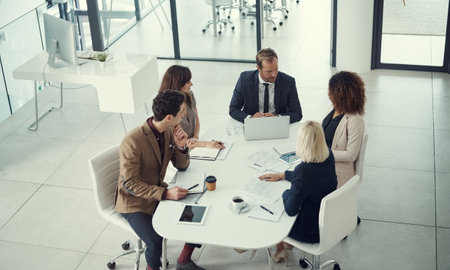 Big talk in the boardroom. a team of colleagues having a meeting in a modern office.の写真素材