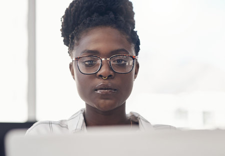 Black woman, entrepreneur and focus on computer at the office for online search for business....