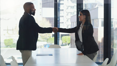 Deal, welcome and handshake with business people in meeting for teamwork, partnership and contract. Collaboration, thank you and job interview with man and woman in office for hiring and networkingの写真素材