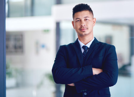 Business man, office portrait and arms crossed with company vision, management and motivation. Success, male employee and professional lawyer in a law firm with corporate job pride and confidenceの写真素材