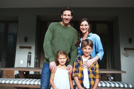 There is so much happiness in this family. Portrait of a young family in the backyard at home.の写真素材
