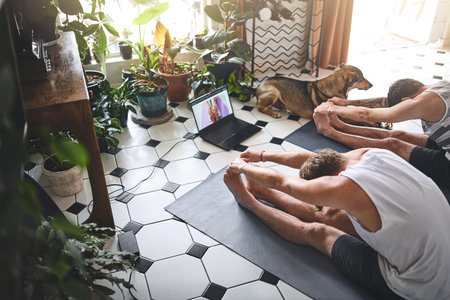 A lengthy stay at home takes mental and physical stamina. two men using a laptop while going through...