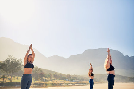 Its the small things that help you grow. three young women practicing yoga on the beach.の写真素材