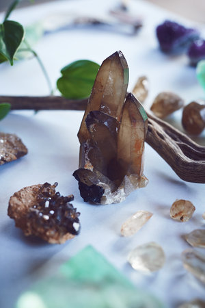Standing out of the crowed. High angle shot of a table filled with different types of crystals inside during the day.の写真素材