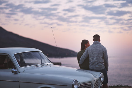 Our love is deeper than simple dates. a young couple making a stop at the beach while out on a road trip.の写真素材