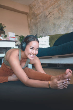 Exercise will greatly transform your life. a young woman stretching her legs while exercising at...