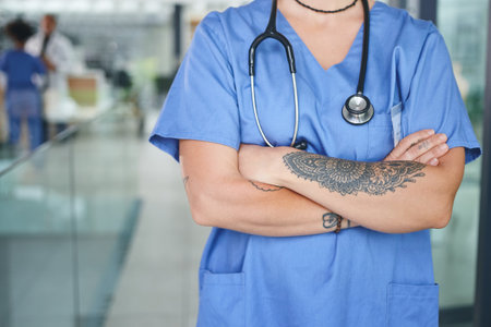 Bringing some open-mindedness to professional careers. an unrecognizable nurse standing in the clinic during the day with her arms folded.の写真素材