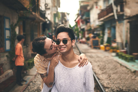 See how happy she makes me. a young couple sharing a romantic moment in the city of Vietnam.の写真素材