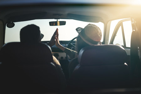 We made it just in time for sunset. Rearview shot of a young couple on a road trip.の写真素材