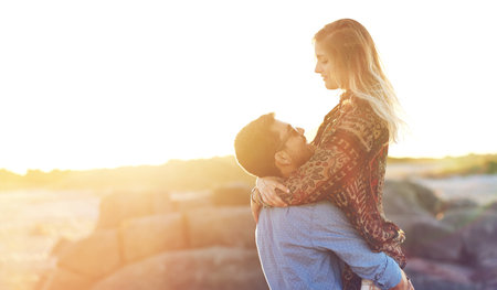 Youre my summer dream come true. an affectionate young couple at the beach.の写真素材