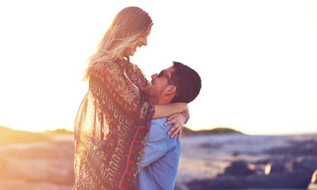 I love to love you. an affectionate young couple at the beach.