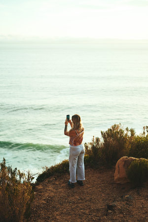 I have to get a picture of this. Full length shot of an attractive young woman standing and taking...