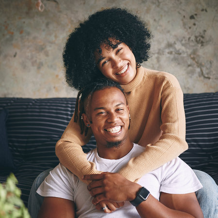 Lovers and best friends at the same time. Portrait of a young couple relaxing together at home.の写真素材