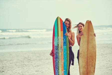 We make surfing look easy. a young couple spending the day out surfing.