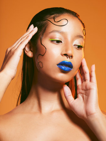 Neon makeup, beauty and portrait of woman in studio for cosmetics, eye shadow and aesthetic. Creative design, cosmetology and face of female person with blue lipstick for glamour, fashion and styleの写真素材