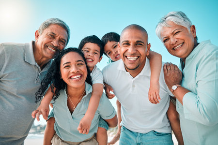 Family, happy and portrait at beach for summer with children, parents and grandparents for fun. Happy men, women and boy kids playing for happiness on a holiday with love, care and support outdoorの写真素材