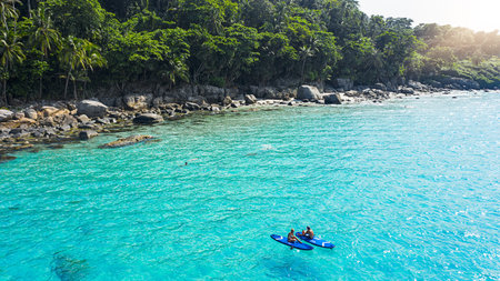 What an awesome day to be out on the water. a man and woman paddle boarding across the sea.
