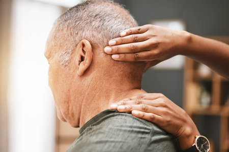 Physiotherapy, neck pain and senior man with physiotherapist for massage, injury and arthritis. Physical therapy, elderly male and patient consulting chiropractor for joint, muscle and spine reliefの写真素材