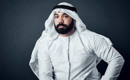 Look to yourself if you want your business to succeed. Studio shot of a young man dressed in Islamic traditional clothing posing against a dark background.の写真素材
