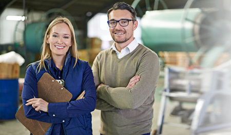 You can depend on us. Portrait of a two smiling managers standing on the warehouse floor.の写真素材