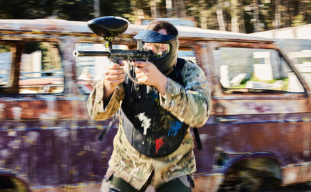 Aim, shooting and paintball man with gun for outdoor battlefield, playground or games in forest...